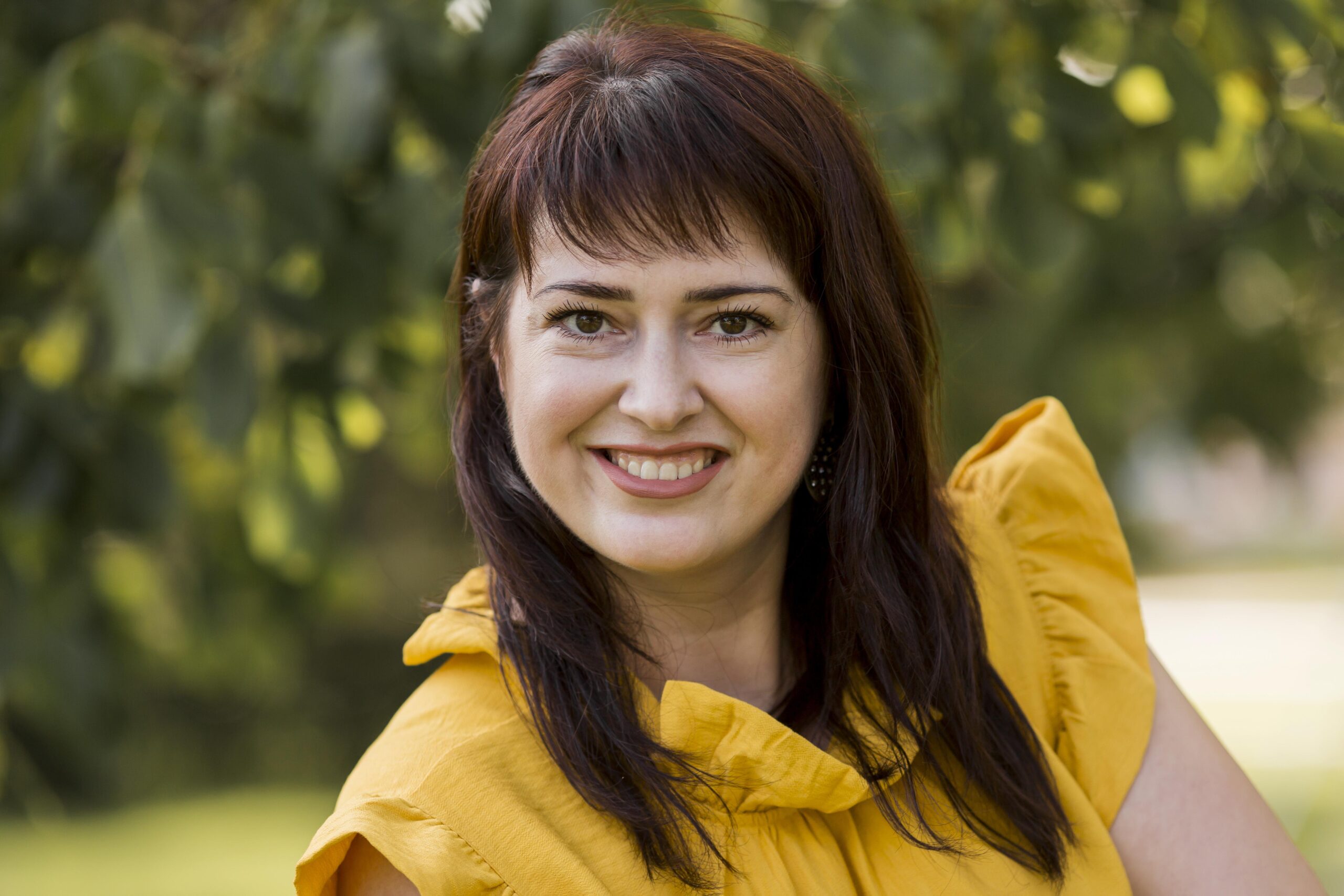 smiley woman posing yellow dress outdoors scaled